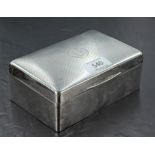 A George V silver cigarette box, of hinged rectangular form with hinged rectangular form with