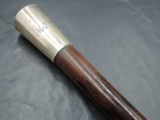 A modern silver topped walking cane, the plain silver tapering domed handle engraved with initials