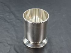 A 1970's silver toothpick holder, of cylindrical form with moulded rim and engine-turned body raised