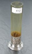 A silver and glass stem vase having cylindrical amber glass vase in a moulded silver base,