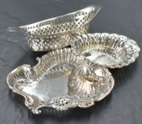 A group of three silver dishes, each of shaped and pierced form with various dates and maker,