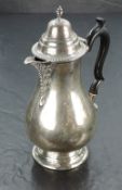 An Edward VII silver hot water pot, hading a moulded and domed finial topped cover with gadrooned