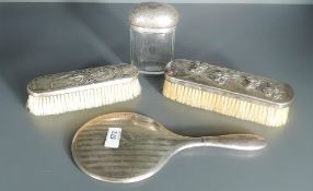 A selection of silver and white metal mounted dressing table wares, comprising a hand mirror, two