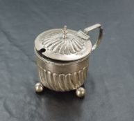 A Victorian silver mustard, of circular form with spiral gadrooning to the domed cover and body,