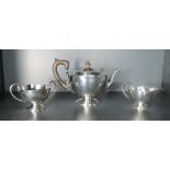 A 1920's three piece silver teaset, of circular form with shaped rims, marks for Sheffield 1922,