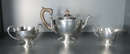 A 1920's three piece silver teaset, of circular form with shaped rims, marks for Sheffield 1922,