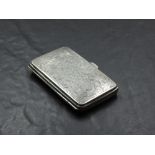 A George V silver cigarette case, of hinged rectangular form, engraved with foliate scrolls, gilt