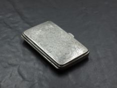 A George V silver cigarette case, of hinged rectangular form, engraved with foliate scrolls, gilt