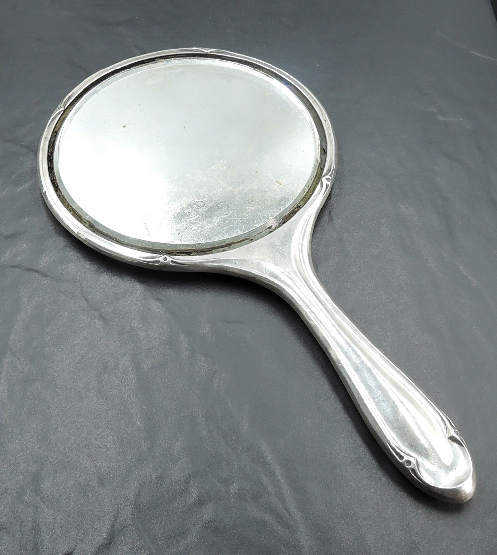 A George V silver hand mirror, of traditional form with muted stylised detail, marks for - Image 2 of 2