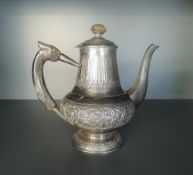 An Eastern white metal teapot, of spreading and bulbous circular form, with horn finial topped cover