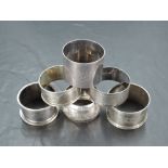 A group of six mixed silver napkin rings, of various size and design with differing dates and