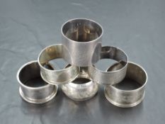 A group of six mixed silver napkin rings, of various size and design with differing dates and