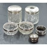 A group of silver mounted glass wares, a pair of silver rimmed cut-glass salts, a pair of silver