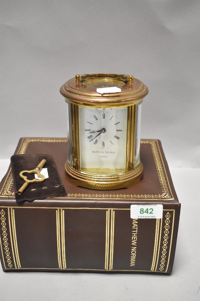 A 20th century Matthew Norman carriage clock having brass case with visible escape movement