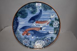 A modern Japanese ceramic charger plate with image of carp