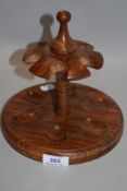 A 20th century turned and carved mahogany pipe smokers rack