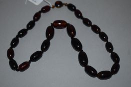 A knotted string of graduated cherry amber beads