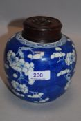 An early 20th century Chinese porcelain ginger jar decorated with traditional cherry blossom