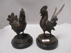 Two 20th century bronze figure sculptures of a hen and cockerel set on black marble bases
