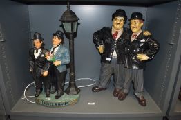A modern figure base set of Stan Laurel and Oliver Hardy with a similar designed lamp base
