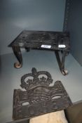 A cast iron fire side trivet with a later copy of an Insurance plaque for Shrewsbury commercial