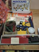 A selection of Meccano parts, motor and Outfit booklets