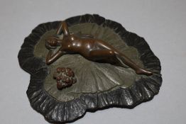 A 20th century miniature bronze figure of nude lady reclining
