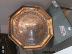 A 20th century octagonal Indian tray inlaid with copper on brass and image of Hindu diety