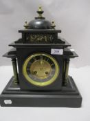 A Victorian black slate mantel clock of Gothic American design having column supports and brass