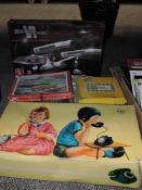 A selection of jigsaw and puzzles also a AMI U.S.S Enterprise model and a childrens telephone set