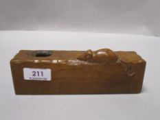 A 20th century Robert Mouseman Thompson golden oak candle holder from the Kilburn workshop having