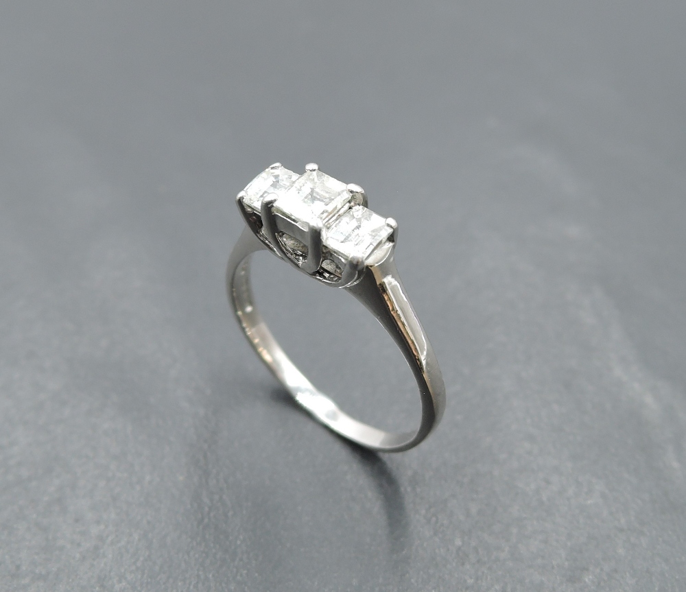 A princess cut diamond trio dress ring, total approx 0.65ct in a claw set stepped looped mount on an