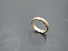 A 9ct gold wedding band having moulded decoration, size L & approx 3g