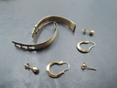 A small selection of 9ct gold including stud and loop earrings and a broken watch strap, approx 10g
