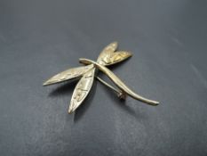 A yellow metal brooch stamped 9K modelled as a dragonfly, approx 3.8g