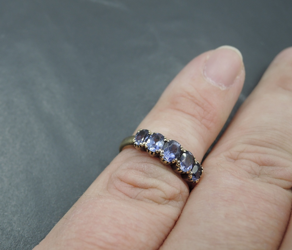 A five stone amethyst style ring having claw set collared mount and yellow metal loop stamped 375, - Image 3 of 3