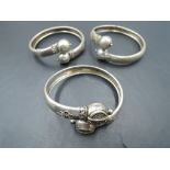 A trio of Oriental white metal tension bangles, all having ball tips, thought to be a mid 19th