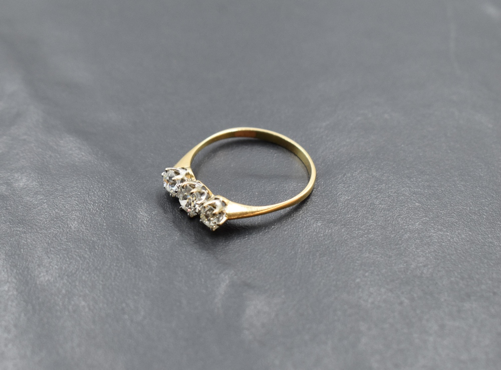 A diamond trilogy ring, total approx 1.25ct in a claw set mount on a yellow metal loop, no marks, - Image 2 of 3