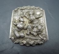 A white metal brooch having repousse decoration of a couple of Siam dancers, no marks tests as