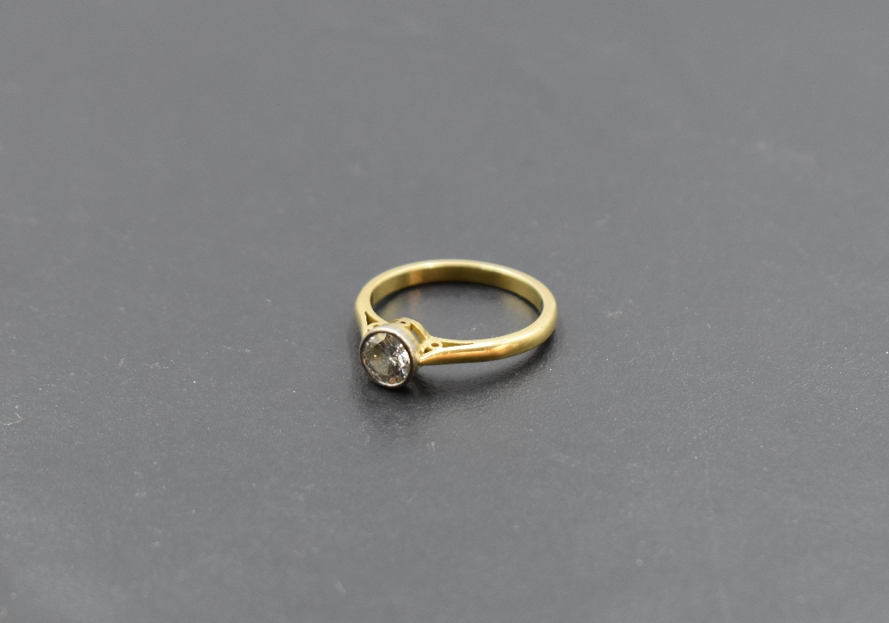 A diamond solitaire dress ring, approx 0.60ct in a collared mount on an 18ct gold loop, size M & - Image 2 of 3