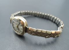 A lady's small 9ct gold wrist watch by Everite having baton numeral dial to champagne face in gold