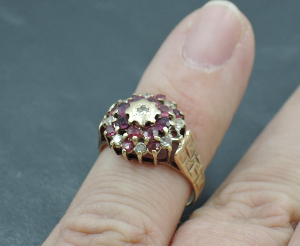 A ruby and diamond chip triple cluster ring in a claw set basket mount with engraved shoulders on - Image 3 of 3