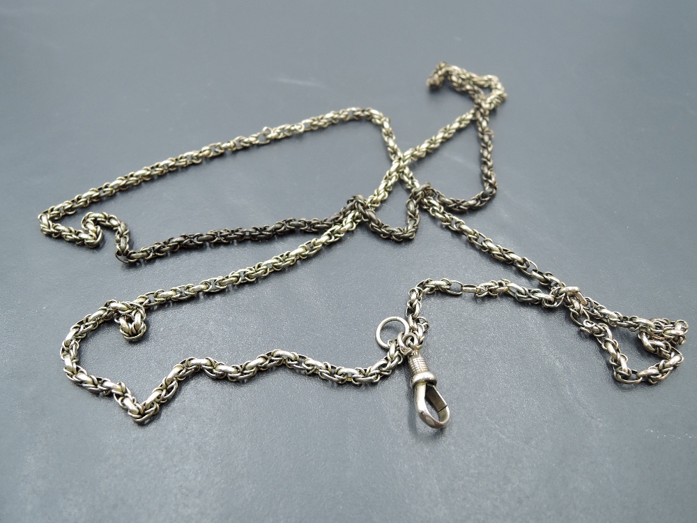 A yellow metal fancy link muff chain with dog leash clasp, no marks but tests as 9ct gold, approx