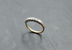 A nine stone diamond half eternity ring in claw set mounts on an 18ct gold loop, size L & approx 2.