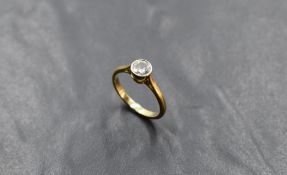 A diamond solitaire dress ring, approx 0.60ct in a collared mount on an 18ct gold loop, size M &