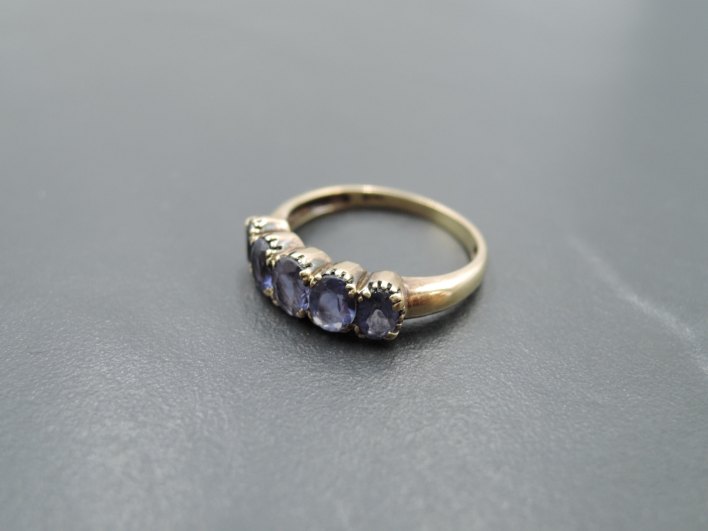 A five stone amethyst style ring having claw set collared mount and yellow metal loop stamped 375, - Image 2 of 3