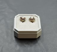 A pair of garnet and seed pearl cluster stud earrings in yellow metal mounts stamped 9ct