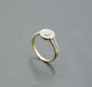 A diamond chip dress ring having a circular cluster to set open shoulders on a 9ct gold loop, size l