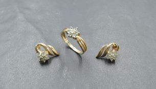 A pair of 9ct gold stud earrings with pale green clusters in decorative leaf settings with a