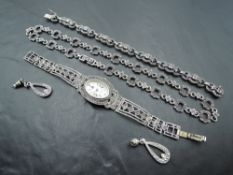 Three pieces of silver and marcasite jewellery including necklace, bracelet and quartz wrist watch